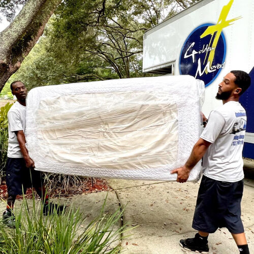 Employees of Lutz FL Moving Company Lifting a Sofa Together
