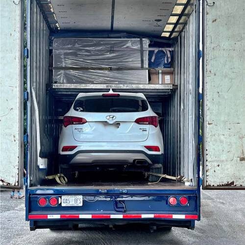Car and Furniture of Couple Relocating To Palm Harbor Florida Loaded in a Moving Company Truck