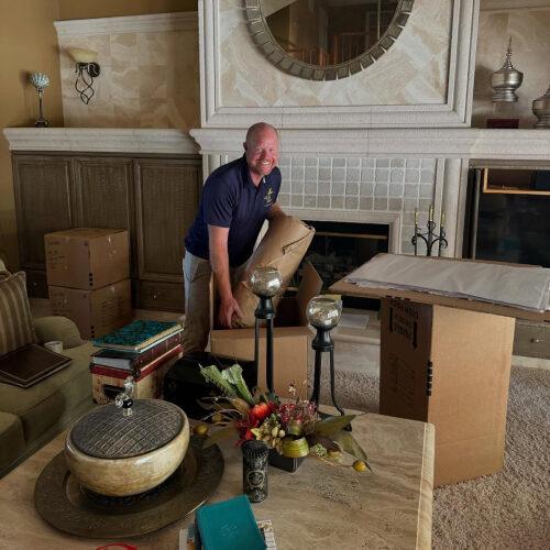 Moving Company Owner Putting Items of Plant City Residents Inside a Box