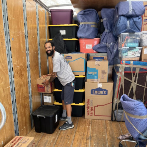 Moving Company Employee Storing Boxes and Furniture of Seminole Heights Family