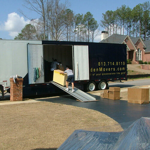 Moving Company Servicing Miami FL Employees of Miami Moving Company Putting Furniture Into the Truck