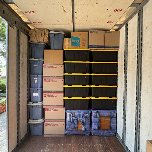 Storage Boxes Stacked Nicely in a Moving Company Truck On The Way to New Port Richey FL