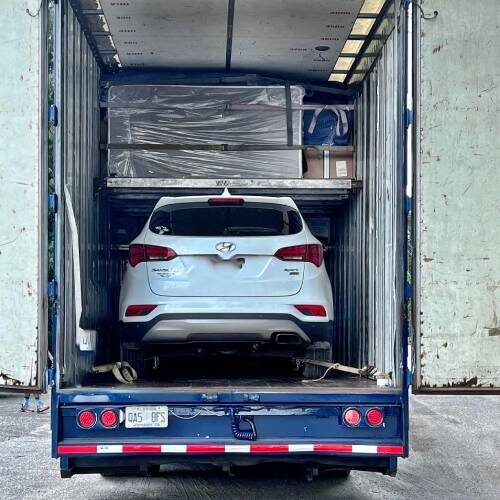 Moving Company in Orlando Florida Car and Furniture of Orlando Couple Inside Truck of Professional Moving Company