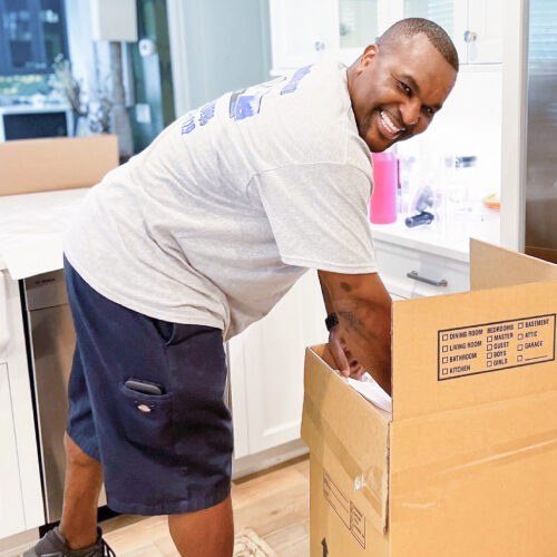 Moving Company in Port St Lucie Florida Port St Lucie Moving Company Employee Carefully Packing Items Into a Box