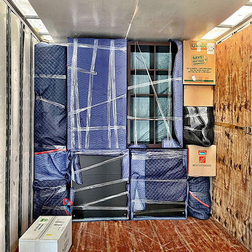 Furniture of a Couple Having a Residential Interstate Move Stacked Properly Inside Vehicle of Tampa-based Moving Company