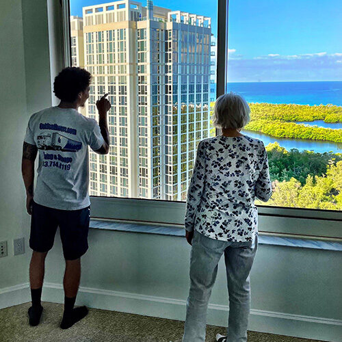 Residential Long Distance Moving Company Tampa Florida Employee of Residential Long Distance Moving Company Pointing to Tampa Lady Where Their Office Is Located