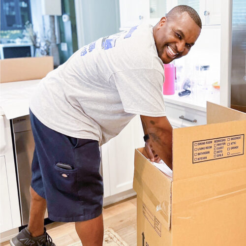 Tampa-based Corporate Relocation Movers Moving Company Employee Packing Executive's Stuff During Corporate Relocation Move to Tampa FL