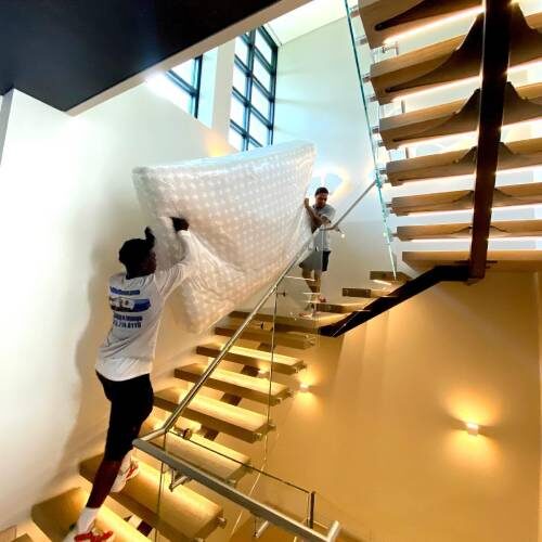 Moving Company Employees Carrying Big Item Full of Bubble Wrap Owned by Tampa Lady